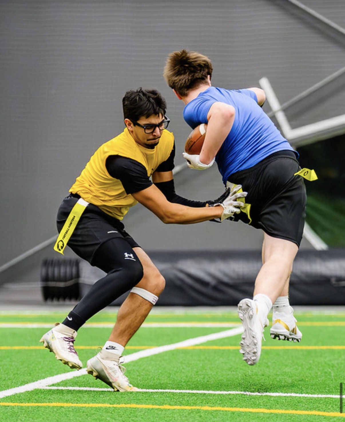 Royals defender pulling the flag of a leaping ball carrier